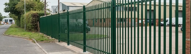 Steel palisade security fencing installed along a commercial site boundary in Surrey