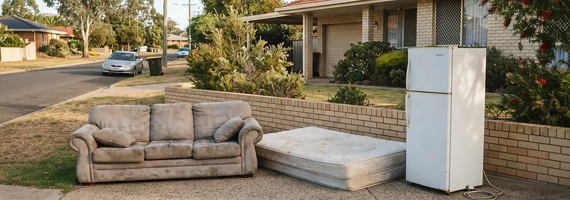 Old sofa, mattress and refrigerator placed in a driveway for collection