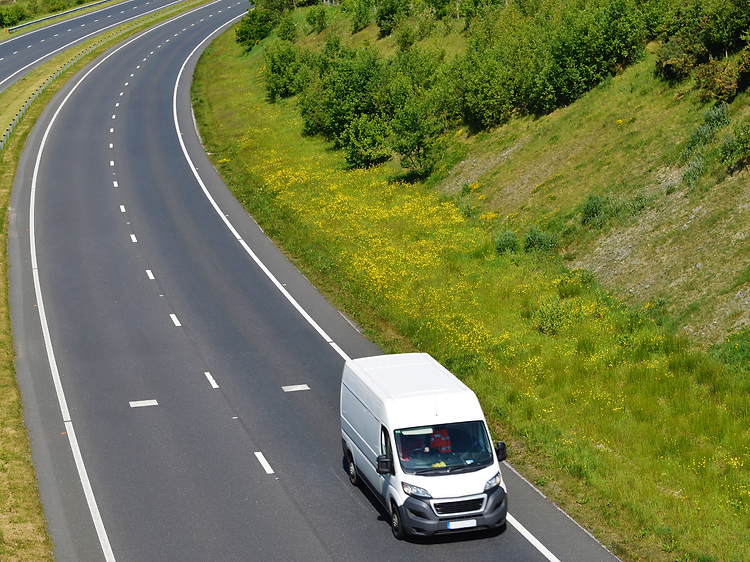Pennine Couriers white cargo van travelling along a rural road