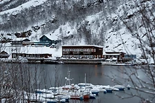 Snow-dusted boats docked at Ersfjordbotn Brygge harbor at twilight