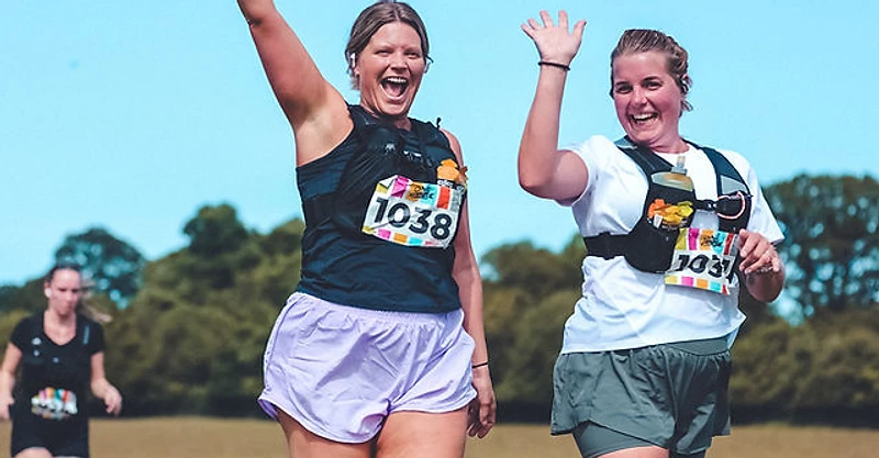 Volunteers cheering at a OneRace aid station