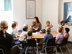 A teacher guides children around a table during a LifeKIDS class