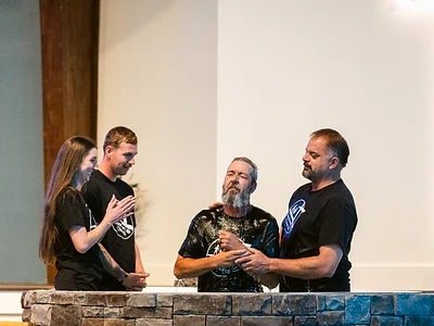 Church family gathers around a man being baptized at Abundant Life Church
