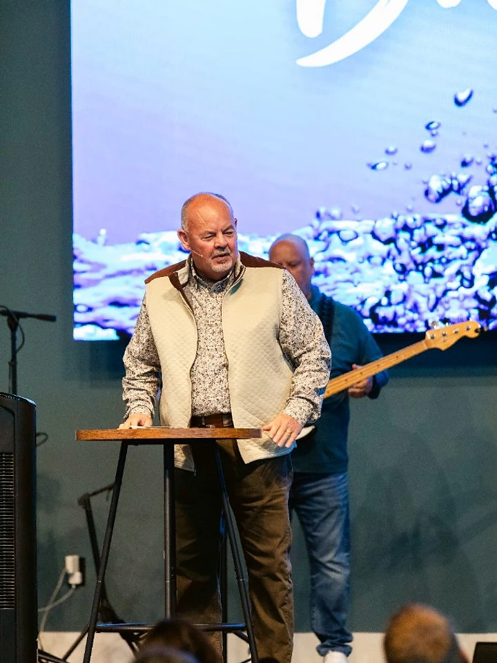 The pastor preaches from the stage during a Sunday message