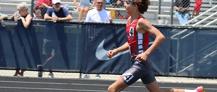 Cherokee Junior Warriors track athlete sprinting down the track