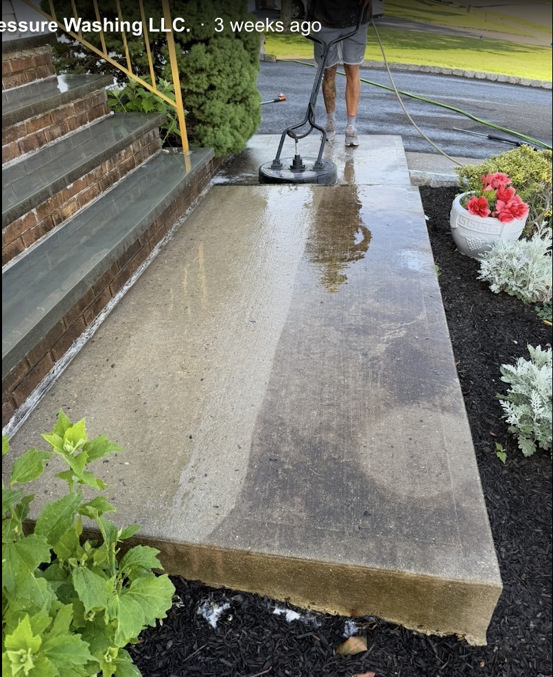 Concrete walkway being cleaned with surface cleaner