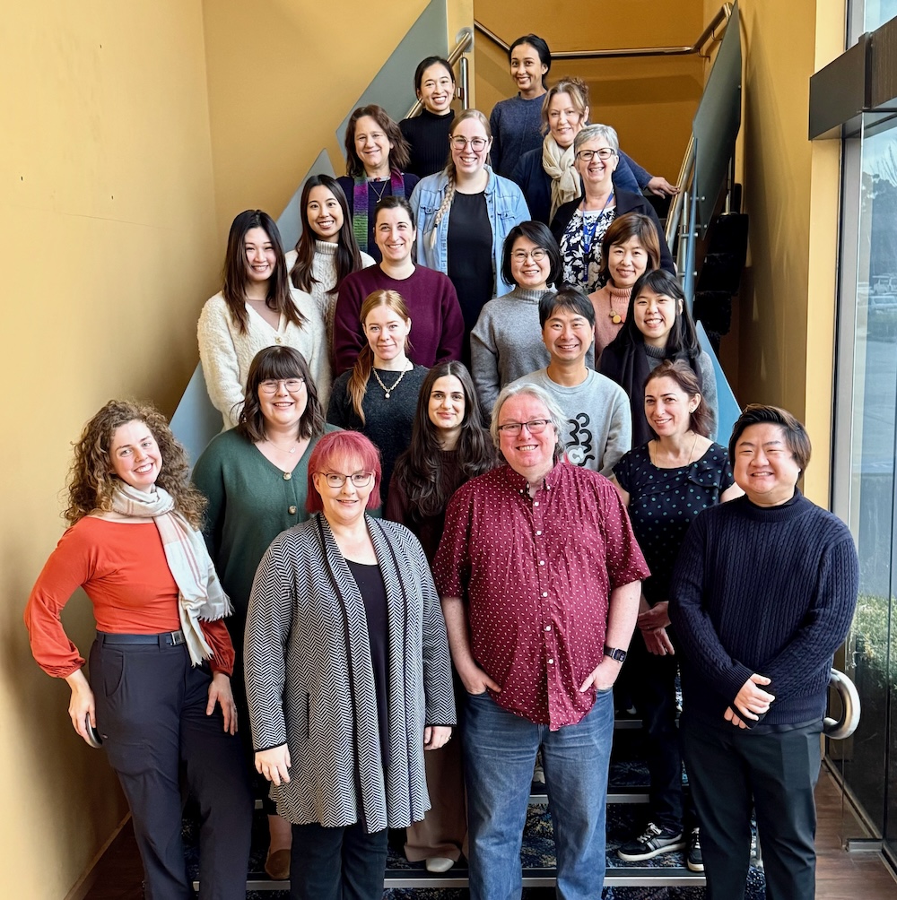 The Okey Dokey Childhood Therapy team posing together on an indoor staircase