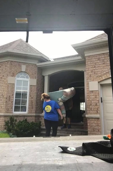 YCML moving labour crew carrying a sofa into a home