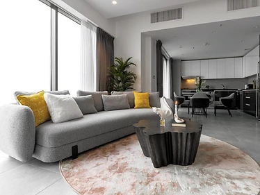 Living room, flat interior design, Amman: open kitchen in the background, mustard and white cushions, round area rug