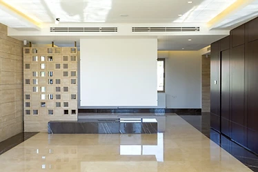 Living hall as built, duplex interior design, Amman: breeze-block screen, white wall panel, walnut wall units