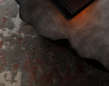 Coffee table detail, flat interior design, Amman: sculptural black stone surface, warm accent lighting