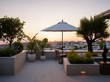 Rooftop terrace corner in Khalda, Amman: umbrella seating, olive tree, bronze falcon sculpture.