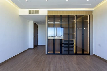 Bedroom as built, duplex interior design, Amman: glass-fronted wardrobe and wood floor