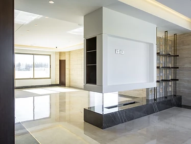 TV wall as built, duplex interior design, Amman: dark marble fireplace bench and steel shelving