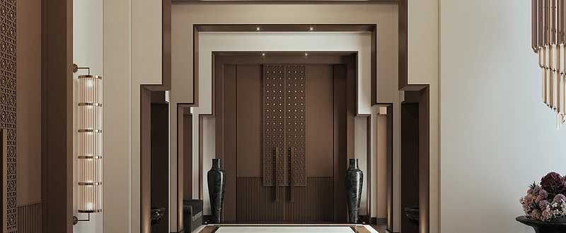 Kuwait commercial hospitality entrance with layered geometric portals, patterned doors and polished stone flooring