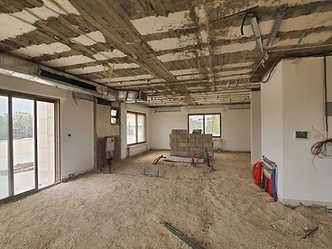 Before: living area, duplex interior design, Amman: stripped ceiling, block stacks, exposed pipes