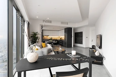 Dining and kitchen, flat interior design, Amman: open white cabinetry, round table, string lights