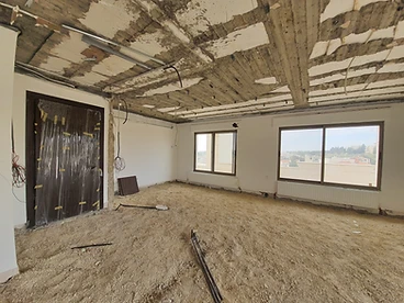 Before: living hall, duplex interior design, Amman: stripped ceiling, bare screed floor, cables