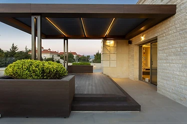 Pergola and deck, roof terrace design, Amman: wood planter in front, stone-clad wall and glass door behind