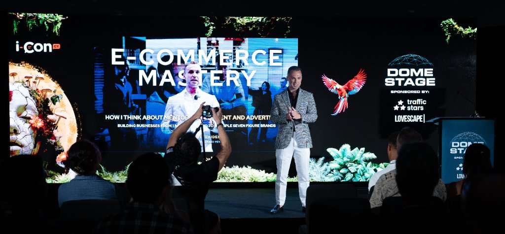 James Demetriades speaking on stage at the E-Commerce Mastery event