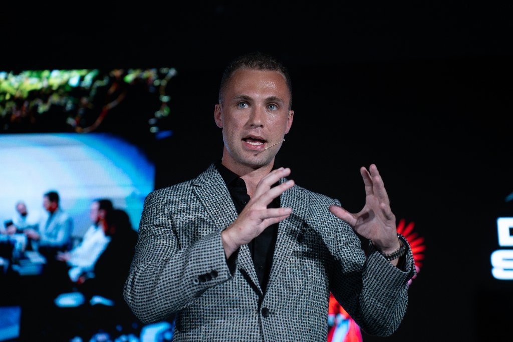 James Demetriades speaking on stage
