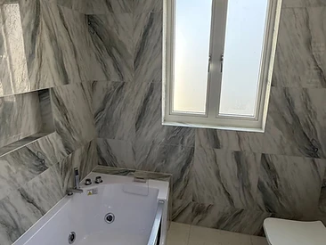 Modern Bathroom with Whirlpool Bath in London by Harris Construction