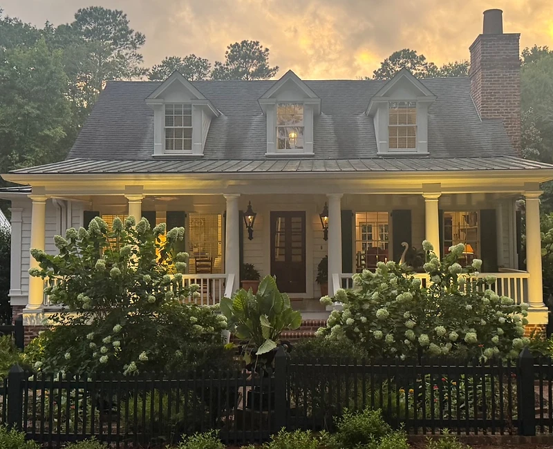 Illuminated white farmhouse at golden hour