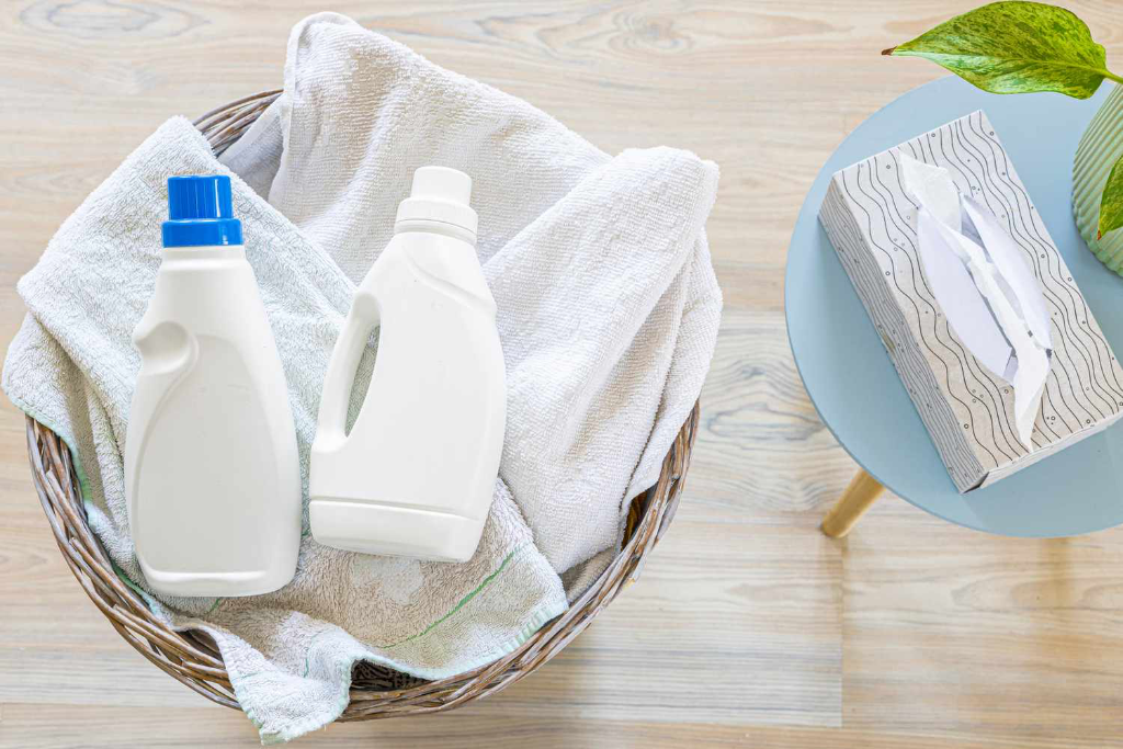 Laundry basket with detergent bottles and towels
