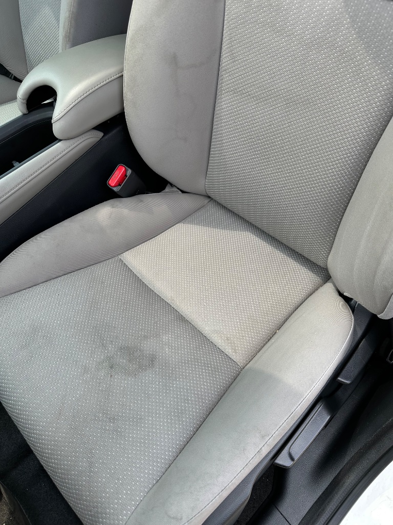 Car seat before interior detailing in Southwestern Pennsylvania