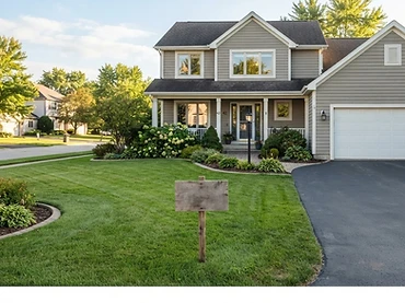 A spacious empty suburban front yard and driveway available to rent for a yard sale
