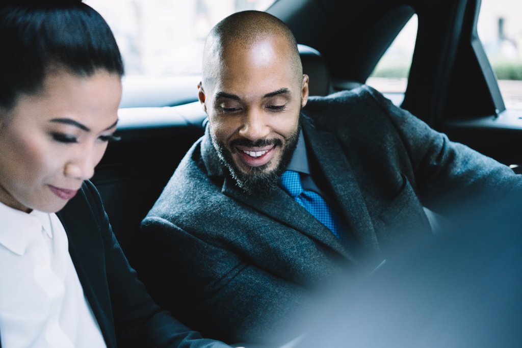 Business professionals in the back of a car