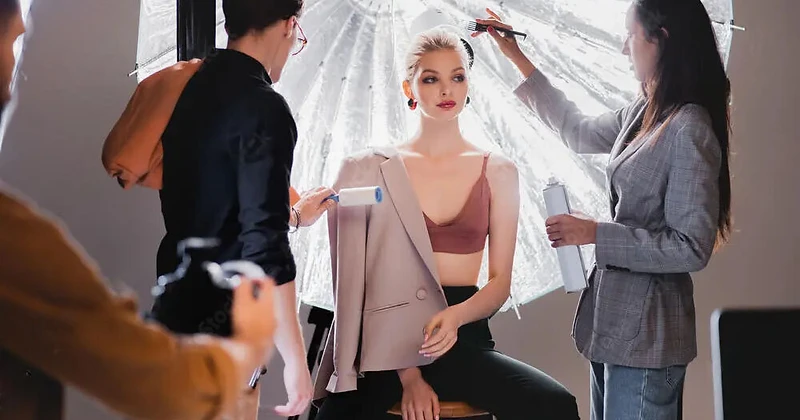 Behind the scenes at Dreams Photography studio in Sydney — makeup artist and stylist preparing a model during a professional wedding photoshoot