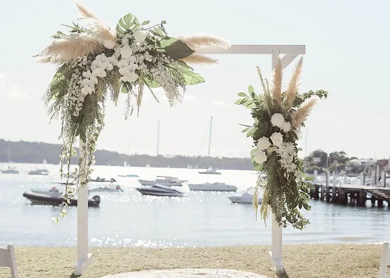 White wedding arbor with pampas grass and orchids overlooking Watsons Bay, Sydney — Dreams Photography