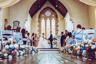 Melinda and Brandyn embracing in front of the historic architecture at their Lords Estate wedding in Sydney