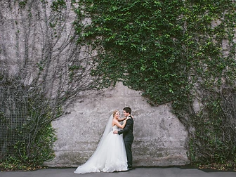 Sydney wedding photography — a couple before a weathered ivy-covered heritage stone wall in The Rocks, Sydney
