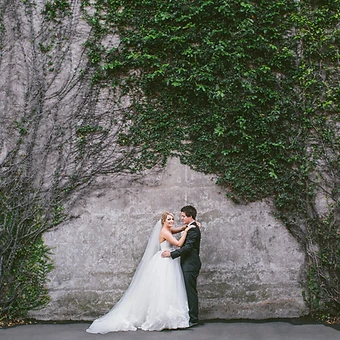 Sydney wedding photography — a couple before a weathered ivy-covered heritage stone wall in The Rocks, Sydney
