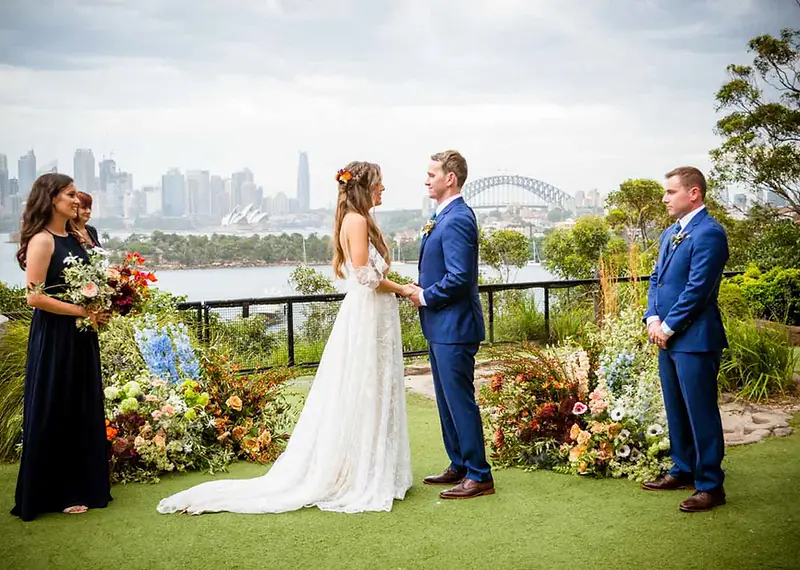 Brit and Ash exchanging vows at their Taronga Zoo wedding overlooking the Sydney Harbour Bridge