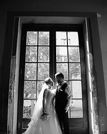 Sydney wedding photography — a bride and groom silhouetted together against a large window in black and white