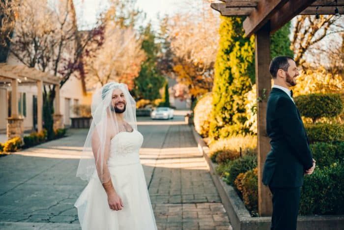 Couple sharing a first look moment in a garden setting during golden hour