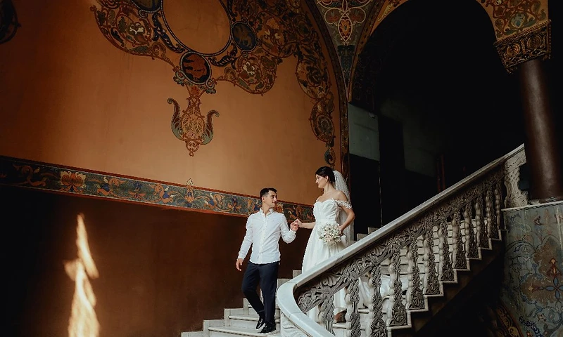 Bride and groom descending a grand ornate marble staircase — cinematic Sydney wedding photography by Dreams Photography