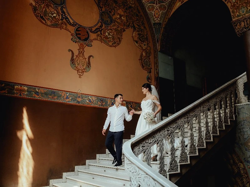 Bride and groom descending a grand ornate marble staircase — cinematic Sydney wedding photography by Dreams Photography