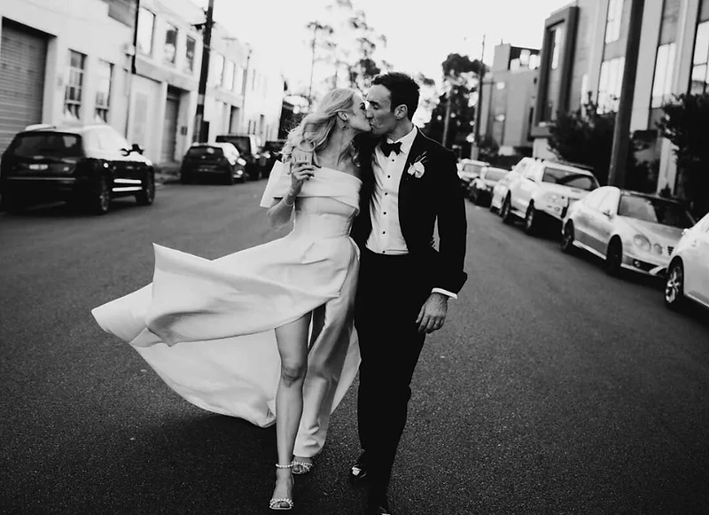 Sydney wedding photography — a bride and groom walking together through Sydney's streets in editorial black and white
