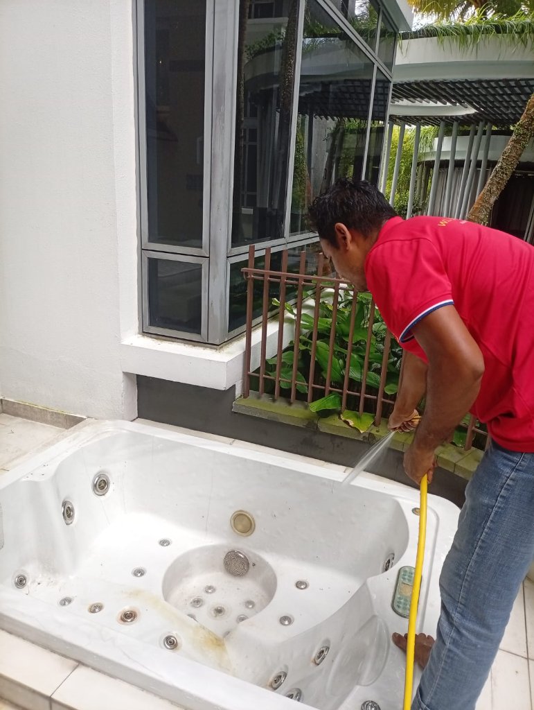 SG Express Cleaning technician — Pressure washing a residential patio and spa