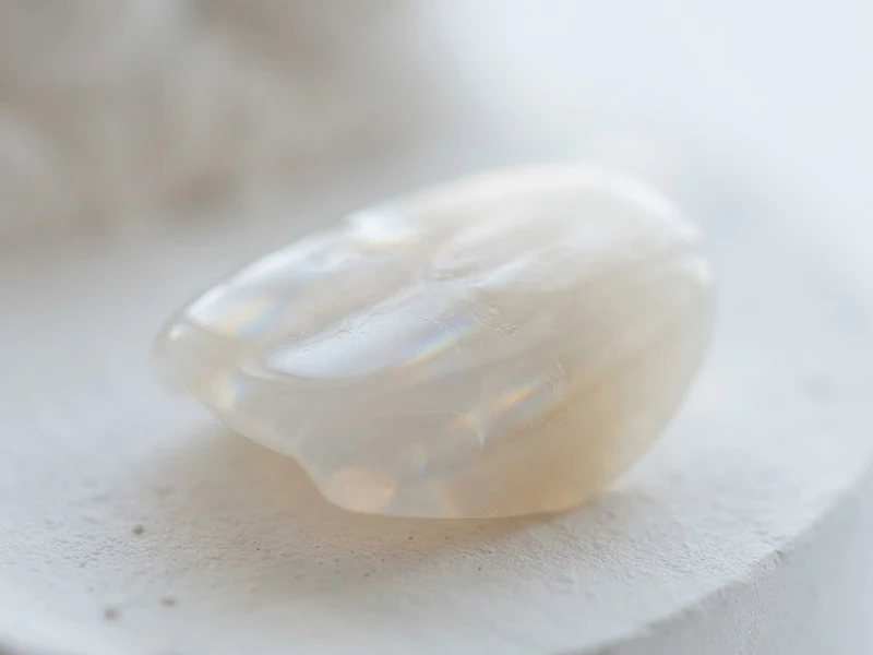 Macro close-up of polished white porcelain ceramic surface with soft prismatic light