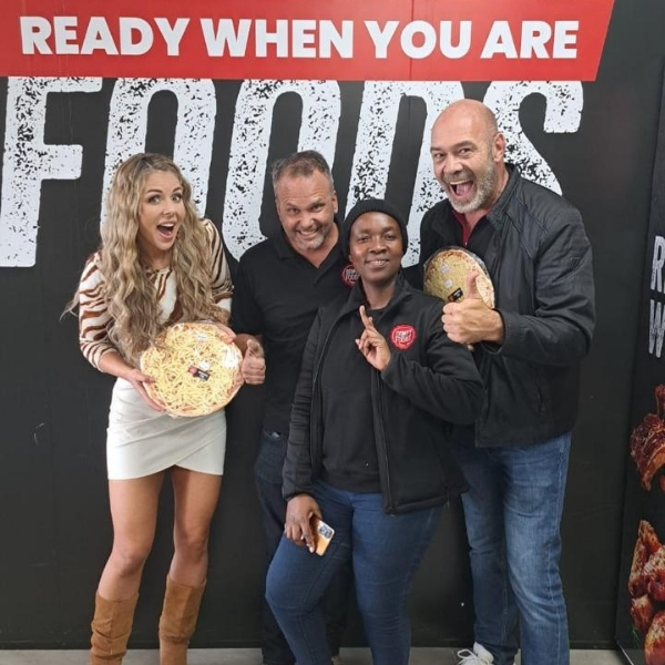 Comfy Foods team in front of branded wall