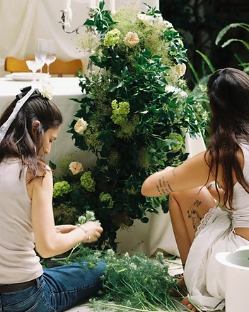 Florists working on sweetheart table arrangement
