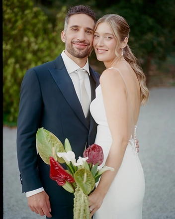 Bride and groom standing together with the bridal bouquet