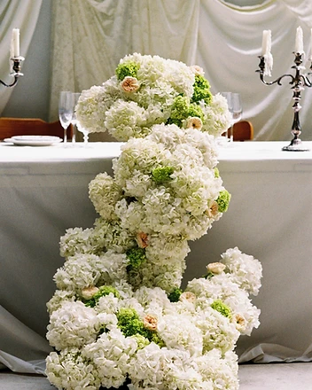 Side view of hydrangea installation with candelabras in background