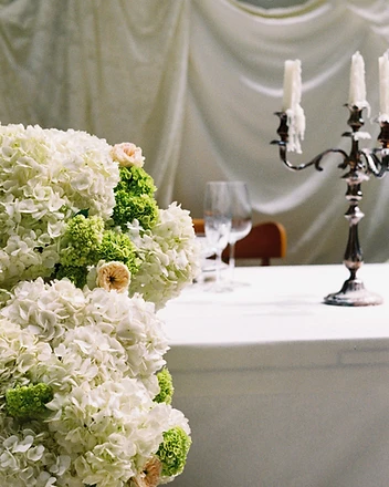 White hydrangea column detail with candelabra behind