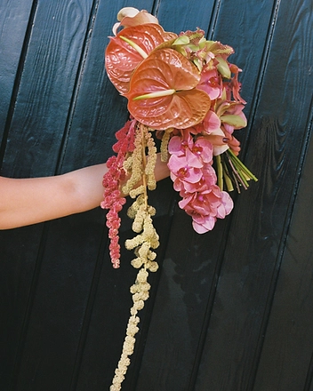 Cascading bouquet against dark wood